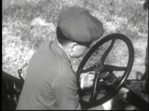 a young person sitting at the steering wheel of a car
