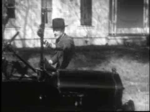 an adult cranking a car engine and getting in