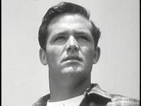 Close-up of a young man looking upward thoughtfully.