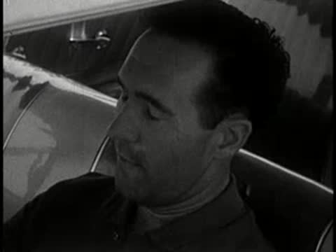 driver blinks and reacts while driving car, 1960s