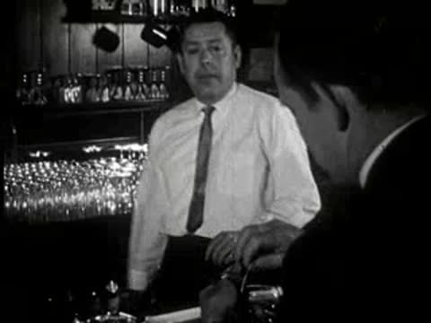 bartender interacting with customer at bar counter, 1960s