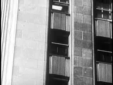 Window washer working on the exterior of a tall city office building