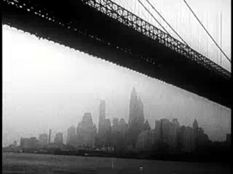 City skyline view framed underneath a large suspension bridge