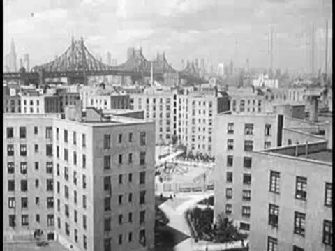 Urban skyline view with bridges and apartment buildings from above.