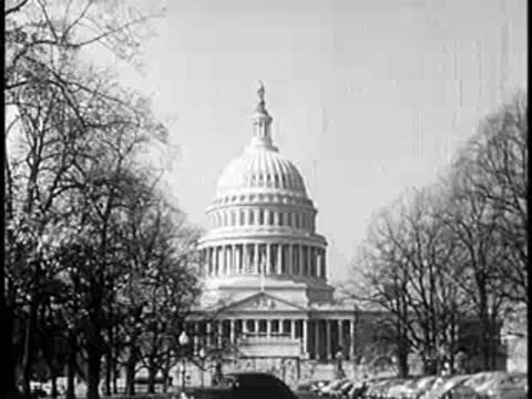 The United States Capitol building surrounded by bare trees