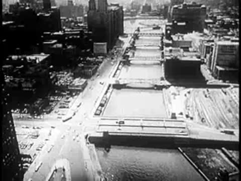 Aerial view of a river cutting through a bustling metropolitan city center.