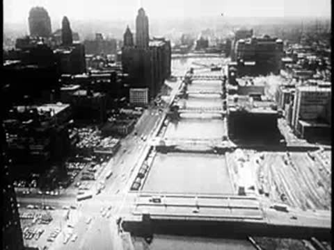 Aerial view of a river and bridge infrastructure in a large city.
