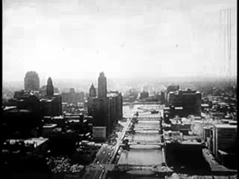 High-altitude aerial view of a city fading into a bright white exposure.