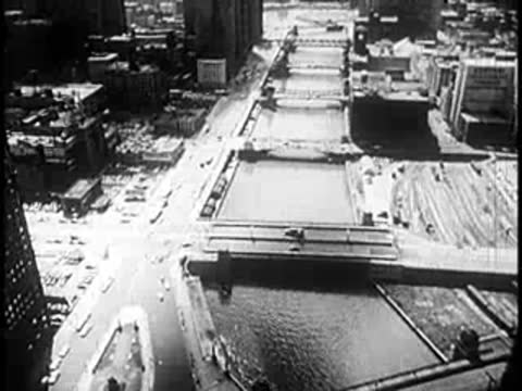 Aerial view of a city riverfront and bridges