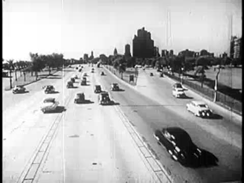 Heavy traffic of vintage cars driving on a wide multi-lane highway