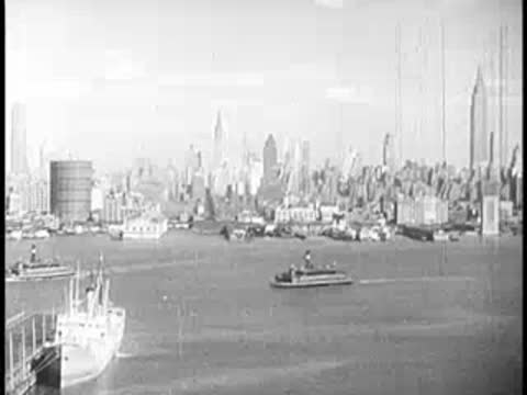 Panoramic harbor view of a coastal city with boats and skyline