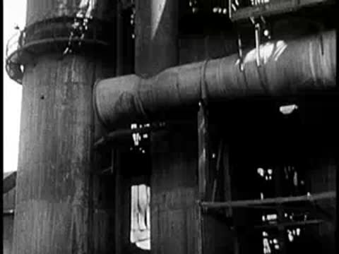 Industrial steel production facility with molten metal pots and pipes.