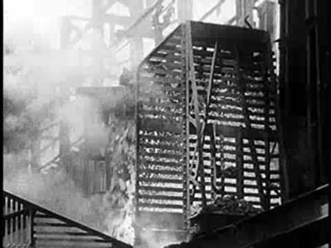 Industrial furnace structure with smoke and activity.