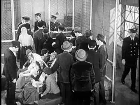 Crowd of people waiting inside a transit station or immigration hall