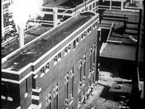 High-angle view of industrial brick buildings with smoking chimneys
