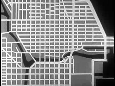 Animated overhead street map zooming in closer on a specific urban section