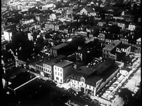 Zooming out from an aerial view over a dense city neighborhood