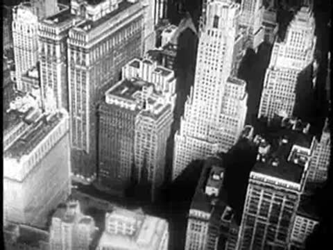 High-angle view of dense urban skyscrapers and downtown office buildings, mid-20th century