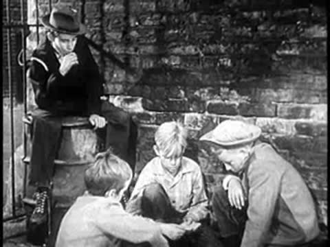 Three boys sitting and kneeling together on a stone stoop in a city alleyway