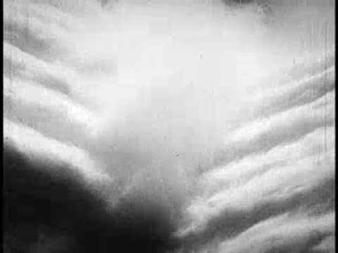 Abstract puffy white clouds moving across the sky, vintage educational film footage