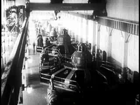 Interior of a large industrial power plant with massive turbine generators