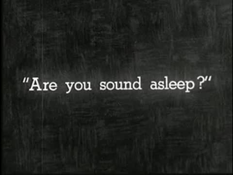 Intertitle asking if the subject is sound asleep, static black and white.