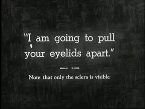 Intertitle stating "I am going to pull your eyelids apart." with note below, static black and white.
