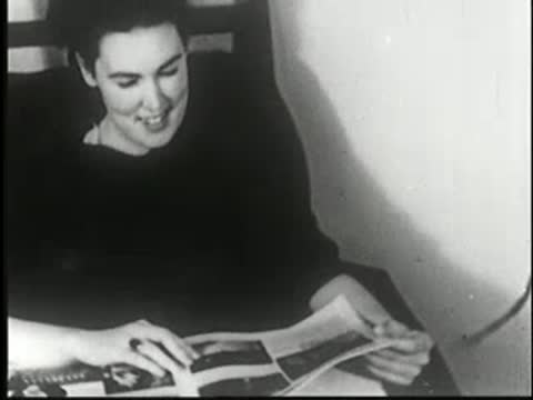 A person continuing to read a magazine with a slight smile.