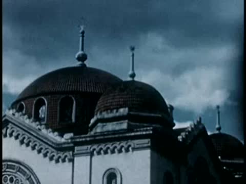 Twin domes of a historic European-style cathedral, 1940s film style