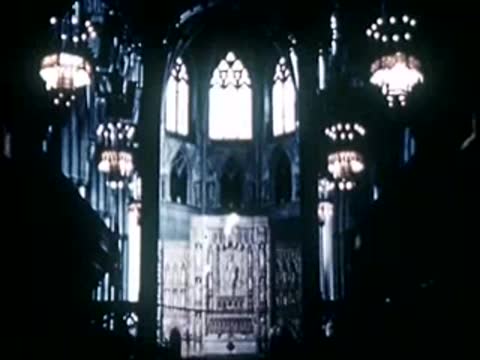 Interior view of cathedral with glowing stained-glass windows, 1940s film style