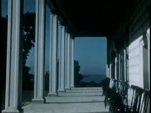 Covered porch with white columns looking toward water
