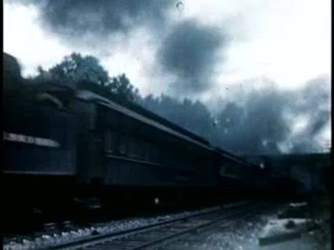 Steam locomotive pulling passenger cars with thick smoke, 1940s film style