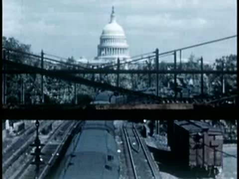 US Capitol dome seen from train crossing a bridge, 1940s film style