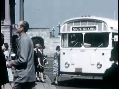 Tourists boarding a sightseeing bus, 1940s film style