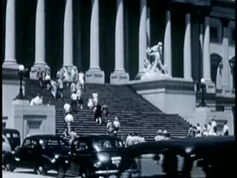 Exterior stairs of US Capitol crowded with visitors, 1940s film style