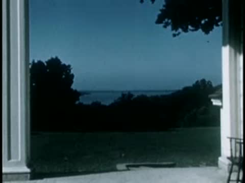 View of water and distant shoreline from mansion porch