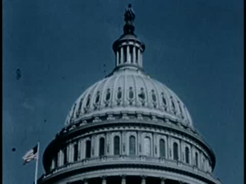 Low angle shot of the US Capitol dome and flag, 1940s film style