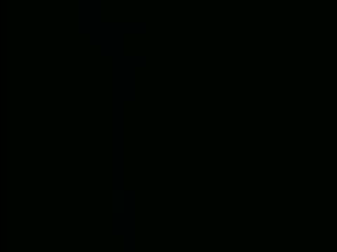 Very dark, barely visible The End title card fading out.