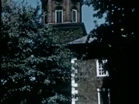 Brick church tower viewed through trees
