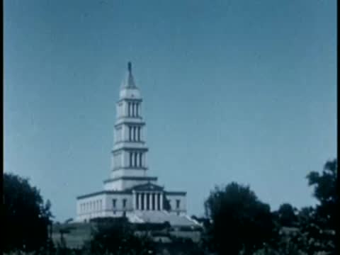 Tall multi-tiered monument tower under blue sky