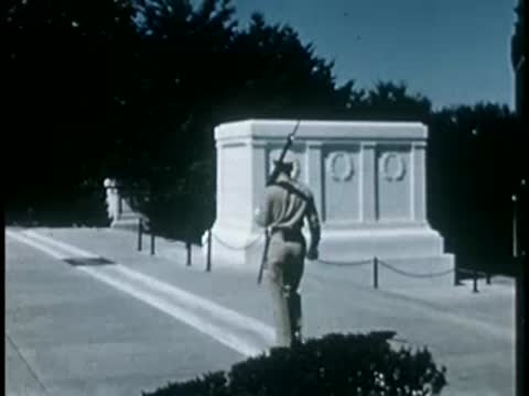 Guard marching near white marble tomb structure