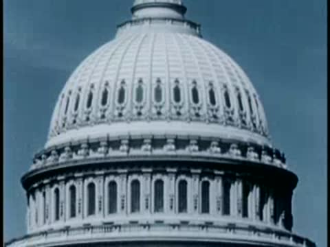 Close-up tracking shot moving up the dome of the U.S. Capitol building.