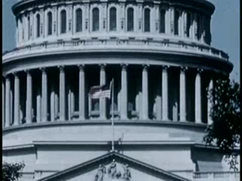 Close-up view of the columns and American flag on the U.S. Capitol building.