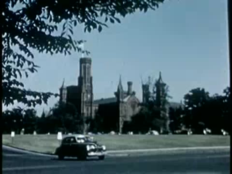 Smithsonian Institution building with car passing on the street in Washington D.C.