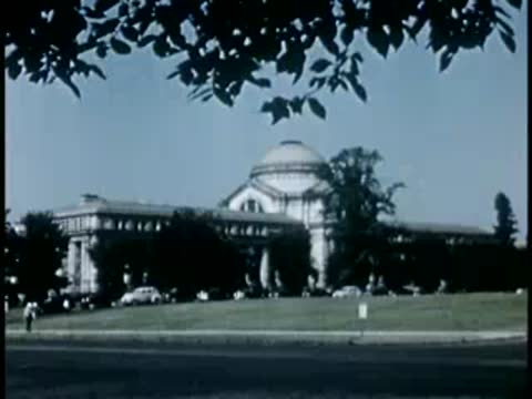 National Museum of Natural History building exterior with parked cars in Washington D.C.