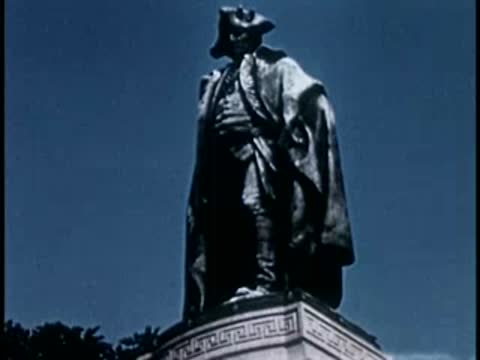 Statues of historical figures on pedestals including an equestrian statue