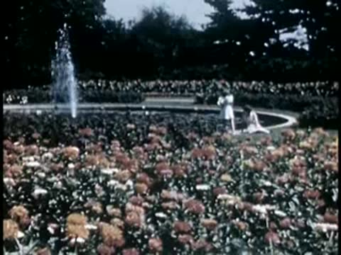 Formal garden with a large fountain and blooming flowers
