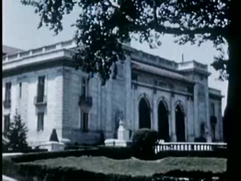Exterior of a large stone building with arched windows