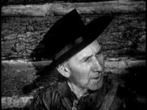 elderly man wearing a hat looking to the side indoors