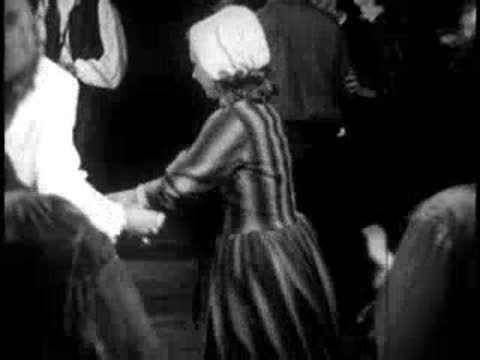 people folk dancing indoors, historical clothing, candlelight